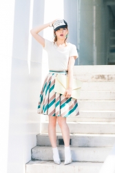 This is a full body photo of Ms. Rikomi Nakajyo, she is a Japanese & Asian mature beauty fashion model, her height is 171 cm and she is tall, she is wearing a hat and wearing a white T-shirt, mixed color Skirt, her style is very good.