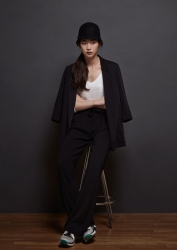 Ms. Anju Eoka was born in 1995 & she is 176 cm tall, she is a Japanese & Asian fashion model & catwalk model (runway model), this is a full-length photo of her tall girl, she is a tall & slender, she is wearing black clothes, a white shirt and athletic shoes.