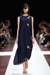 This is a photo of Ms. Anju Eoka working as a fashion catwalk model, she is a fashion model & catwalk model (runway model) who appeared on the fashion show, she is tall & slender, she is wearing a blue dress.