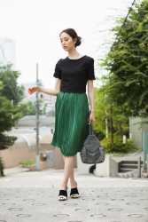 Ms. Arine is a very beautiful & elegant Japanese & Asian beauty fashion model, she is 173 cm, she is tall and slender, she is standing on the road, wearing a black shirt and a green skirt.
