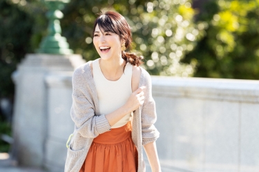 Ms. Rikomi Nakajyo is a mature Japanese & Asian beauty fashion model, her height is 171 cm and she is tall, she is wearing a light gray sweater, white short-sleeved blouse, and orange skirt, her style is very good.