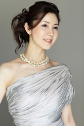 Ms. Keina Ashikubo is wearing a light blue dress, she is standing, she has a pearl necklace around her neck, she is a Japanese & Asian mature beauty fashion model, her height is 170 cm, she is very slim and beautiful, elegant.