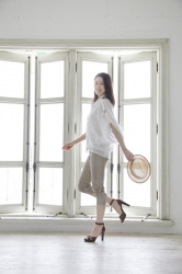 Ms. Keina Ashikubo is wearing a white short-sleeved blouse, beige trousers, black high heels and holds a hat in her hand, she is a Japanese & Asian mature beauty fashion model, she is 170 cm tall and has a very slim and beautiful, elegant figure.