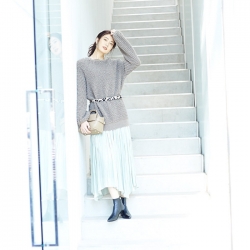 Ms. Hikane Doki is wearing a grey long-sleeved shirt, light blue skirt and a bag in her right hand, she is a Japanese & Asian beautiful fashion model.