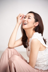 Ms. Namiri Ishiba is wearing a white short-sleeved blouse and pink trousers, she is sitting, she is a Japanese & Asian beautiful and elegant mature female fashion model.