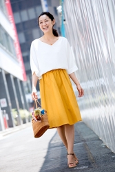 Ms. Namiri Ishiba is wearing a white short-sleeved shirt and yellow skirt, she is a Japanese & Asian beautiful and elegant mature female fashion model.