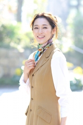 Ms. Namiri Ishiba is very fashionable in the city, she is standing, she wears a white shirt and an ocher dress, she is a Japanese & Asian beautiful and elegant mature female fashion model.