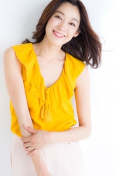 This is a frontal photo of Ms. Namiri Ishiba, she is wearing a yellow short-sleeved shirt and white trousers, she is a Japanese & Asian beautiful and elegant mature female fashion model.