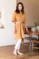 Ms. Namiri Ishiba is wearing orange clothes on her upper body and white trousers on her lower body, she is indoors, she is a Japanese & Asian beautiful and elegant mature female fashion model.