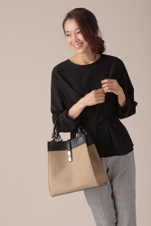 Ms. Namiri Ishiba is wearing a black long-sleeved blouse and gray trousers, she holds a bag in her hand, she is a Japanese & Asian beautiful and elegant mature female fashion model.