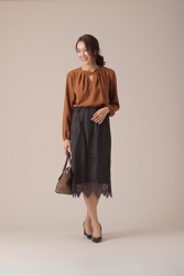 Ms. Namiri Ishiba is standing in a long-sleeved brown blouse and black skirt, she is a Japanese & Asian beautiful and elegant mature female fashion model.
