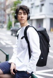 Mr. Ryuutarou Oshikoshi is wearing a white T-shirt･denim shorts with a black backpack on his back, he is a Japanese & Asian handsome fashion model.