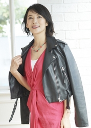 Ms. Tamaki is a Japanese & Asian mature female fashion model wearing a red dress, black leather jacket, and she is standing.