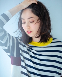 Ms. Hinaka Tsurukubo is wearing a blue and white horizontal striped patterned shirt, she looks down a little, she is a Japanese & Asian mature female fashion model, her height is 171 cm and her figure is very pretty.