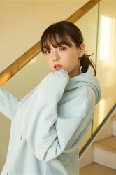 Ms. Aika's bust is 87 cm, she has big breasts, the Japanese & Asian cute glamour gravure idol (bikini model) Ms. Aika is wearing a light blue sweatshirt, she is a sexually attractive woman.