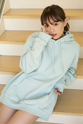 Ms. Aika's bust is 87 cm, she has big breasts, the Japanese & Asian cute glamour gravure idol (bikini model) Ms. Aika is wearing a light blue sweatshirt, she is a sexually attractive woman, she is sitting on the stairs.