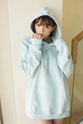 Ms. Aika's bust is 87 cm, she has big breasts, the Japanese & Asian cute glamour gravure idol (bikini model) Ms. Aika is wearing a light blue sweatshirt, she is a sexually attractive woman, she is standing.