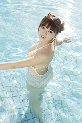 Ms. Aika's bust is 87 cm, she has big breasts, Ms. Aika is a Japanese & Asian cute big breasted gravure idol (swimwear model) in a swimsuit, Ms. Aika soaks in the pool water, she is a sexually attractive woman.