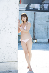 Very cute Japanese & Asian beautiful & cute gravure idol (bikini model), actress, TV personality, her name is Ms. Arian and she is wearing a pink bikini swimsuit, she is standing.