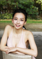 Ms. Asui Hananoi is a Japanese & Asian beautiful cute young slender fashion model, gravure idol (bikini model, swimsuit model, pin-up girl), actress, TV personality wearing a thin pink dress, she is sitting in a chair, her figure is very attractive.