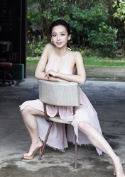 Ms. Asui Hananoi is a Japanese & Asian beautiful cute young slender fashion model, gravure idol (bikini model, swimsuit model, pin-up girl), actress, TV personality wearing a thin pink dress, she is sitting in a chair, her figure is very attractive.