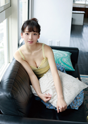 Ms. Asui Hananoi is wearing yellow camisole, light blue skirt, she is sitting on a black sofa, she is a slender Japanese & Asian beautiful cute young fashion model, gravure idol (bikini model, swimsuit model, pin-up girl), actress, TV personality, her figure is very charming.