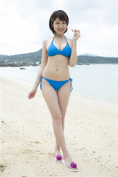 Ms. Chizuka Nakagoe is wearing a light blue bikini swimsuit, she is standing on the beach, she is a Japanese & Asian sweet and cute TV personality, bikini model, actress, her bust is 88 cm, she has big breasts. beautiful breasts, she is a sexually attractive woman.