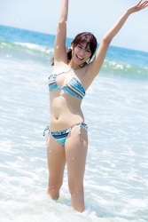 Ms. Ikuho Hisazato was wearing a light blue bikini swimsuit and was photographed on the beach, she stands with her feet in the sea, she is a Japanese & Asian beautiful and famous model, swimsuit model (bikini model, gravure idol, pin-up girl) and TV personality, her bust is 83 cm and she has beautiful breasts.