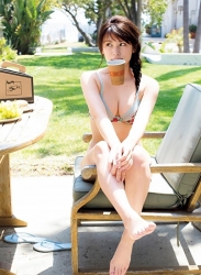Ms. Ikuho Hisazato is wearing a gray bikini and sitting on a chair, she is a Japanese & Asian beautiful and bikini model (swimwear model, gravure idol, pin-up girl) and TV personality, her bust is 83 cm and she has beautiful breasts.