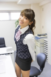 Ms. Ikuho Hisazato is wearing an office lady's clothing, she is standing in the office, she is a Japanese & Asian beautiful and famous model, gravure idol (bikini model, swimsuit model, pin-up girl), TV personality, her bust is 83 cm, and she has beautiful breasts.