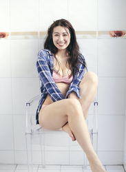 Ms. Aisui Saito is wearing a blue plaid long-sleeved shirt, pink bikini swimsuit, she is sitting on a chair, she is a beautiful and sexy Japanese & Asian gravure idol (bikini model, swimsuit model, pin-up girl), actress, her bust is 85 cm, she has beautiful breasts, she is a sexually attractive woman.