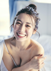 Ms. Aisui Saito is sitting on the bed in a white bikini, she is a beautiful and sexy Japanese & Asian gravure idol (bikini model, swimsuit model, pin-up girl), actress, her bust is 85 cm, she has beautiful breasts, she is a woman with sexual charm.