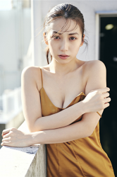 Ms. Aisui is wearing a yellow dress, on the roof of a building, she is a Japanese & Asian beautiful and sexy gravure idol (bikini model, swimsuit model, pin-up girl), actress, her bust is 85 cm, she has beautiful breasts, she is sexually attractive women.