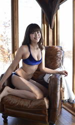 Ms. Amiri Inagawa kneels on a brown chair, showing blue underwear, she is a beautiful and lively Japanese & Asian TV personality, swimsuit idol (bikini model, pin-up girl), baseball lover, her bust is 86 cm, and she has beautiful breasts.
