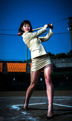 Ms. Amiri Inagawa is wearing a beige woman's suit and swinging a baseball bat, she is a beautiful and lively Japanese & Asian TV personality, swimsuit female model, baseball enthusiast, her bust is 86 cm, and she has beautiful breasts.