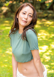 Ms. Maaka Kumagai is wearing a casual green shirt, white pants, she is standing, she is a mature, beautiful and sexy Japanese & Asian TV personality, gravure idol (bikini model, swimsuit model, pin-up girl), mah-jongg expert.