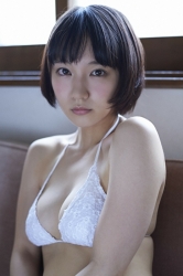 Ms. Rihoko Yoshikoshi is wearing a white bikini swimsuit, and in the house, she is sitting on the sofa, she is a beautiful and elegant Japanese & Asian actress gravure idol (bikini model, swimwear model, pin-up model), she has charming beautiful breasts.