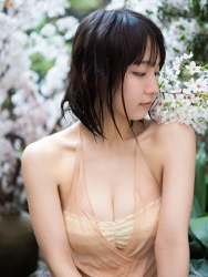 Ms. Rihoko Yoshikoshi is wearing a light yellow bikini swimsuit, flesh-colored slip, her body is wet, she is looking sideways, she is a beautiful and elegant Japanese & Asian actress and swimsuit model, she has charming beautiful breasts.