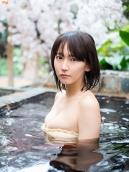 Ms. Rihoko Yoshikoshi is wearing a light yellow bikini swimsuit and is soaking in the hot spring, she is a beautiful and elegant Japanese & Asian actress and swimsuit model, and she has charming beautiful breasts.