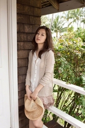 Ms. Yuuri Fuefuki was wearing a beige cardigan, white blouse, light purple miniskirt, took off her straw hat, and stood in front of the door of the house, she is a Japanese & Asian intellectual, delicate and mature beauty actress & model, her title is actress, and she has done a little modeling business.