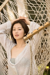 Ms. Yuuri Fuefuki is wearing a light blue cardigan and gray underwear, sitting on a hammock, she is a Japanese & Asian intellectual, delicate and mature beauty actress & model, her title is actress, and she has done a little modeling business.