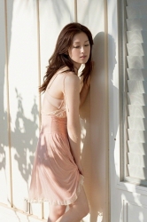 Ms. Yuuri Fuefuki is wearing a pink slip and standing in front of the wall of the house, she is a Japanese & Asian intellectual, delicate and mature beauty actress & model, her title is actress, she has done a little modeling business.