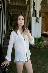 Ms. Yuuri Fuefuki is wearing a white shirt and underpants, she is standing in the garden, she is a Japanese & Asian intellectual, delicate and mature beauty actress & model, her title is actress, she has done a little modeling business.