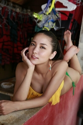 Ms. Miren Ishigane is wearing a bikini swimsuit composed of yellow bra and green panties, she is lying prone, she is a beautiful & cute Japanese (Asian) fashion model, actress, TV personality, bikini model (gravure idol, swimwear model, pin-up girl), her bust is 83cm, she has beautiful breasts.
