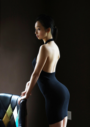 Ms. Asui Hananoi is a young and beautiful Japanese & Asian beautiful cute young slim fashion model, bikini model (gravure idol, pin-up model, swimwear model), actress, TV personality, wearing a black dress, she is standing next to the chair, her figure is very attractive.