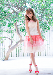 Ms. Ayaka is a very beautiful & cute Japanese & Asian model, freelance announcer, TV personality, wearing a white & pink two-color dress, red shoes, she is standing.