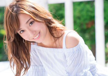 Ms. Ayaka is a very beautiful & cute Japanese & Asian model, freelance announcer, TV personality, wearing a light blue dress, she puts out her teeth and smiles a little.