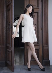 Ms. Hitoha Korekiyo is a tall fashion model, TV entertainer, actress, wearing a white dress, black high heels, she is standing, her bust is 84 cm, and she has beautiful breasts.