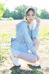 Ms. Naasu Takamichi is a very pure young Japanese & Asian fashion model and actress, wearing light blue casual clothes, shorts and white sneakers, she is crouching.