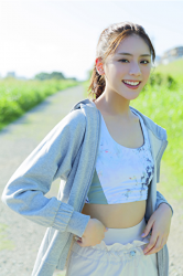 Ms. Naasu Takamichi is a very pure young Japanese & Asian fashion model and actress, wearing light blue casual clothes, she is standing.